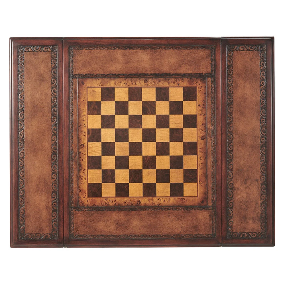 A hand carved and Inlay Game table, the reversible chess and hand tooled leather Inlay top revealing a backgammon board below, the frieze with two opposing end drawers, on spiral turned legs joined by an 'X' stretcher. The original William and Mary.