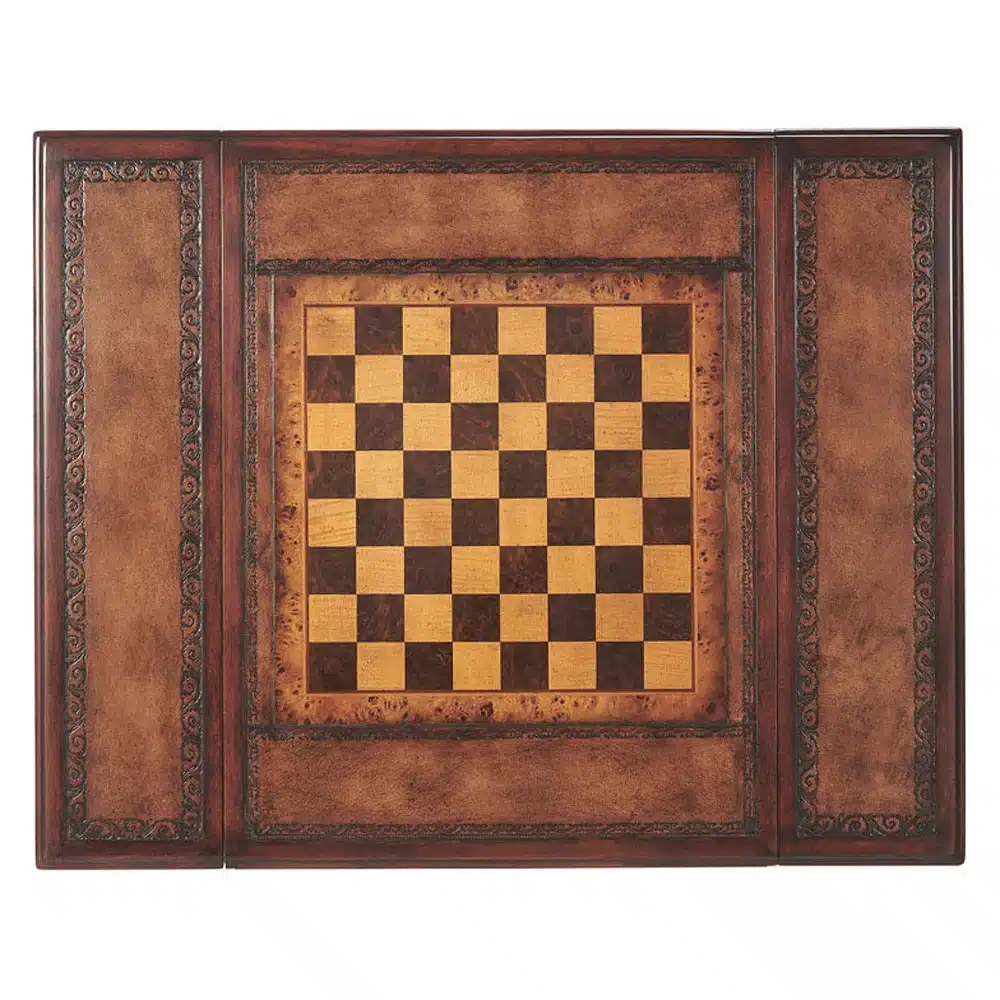 A hand carved and Inlay Game table, the reversible chess and hand tooled leather Inlay top revealing a backgammon board below, the frieze with two opposing end drawers, on spiral turned legs joined by an 'X' stretcher. The original William and Mary.