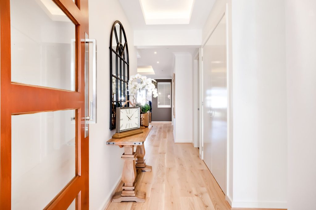 A Small Entrance Room Long Hallway Orange Door