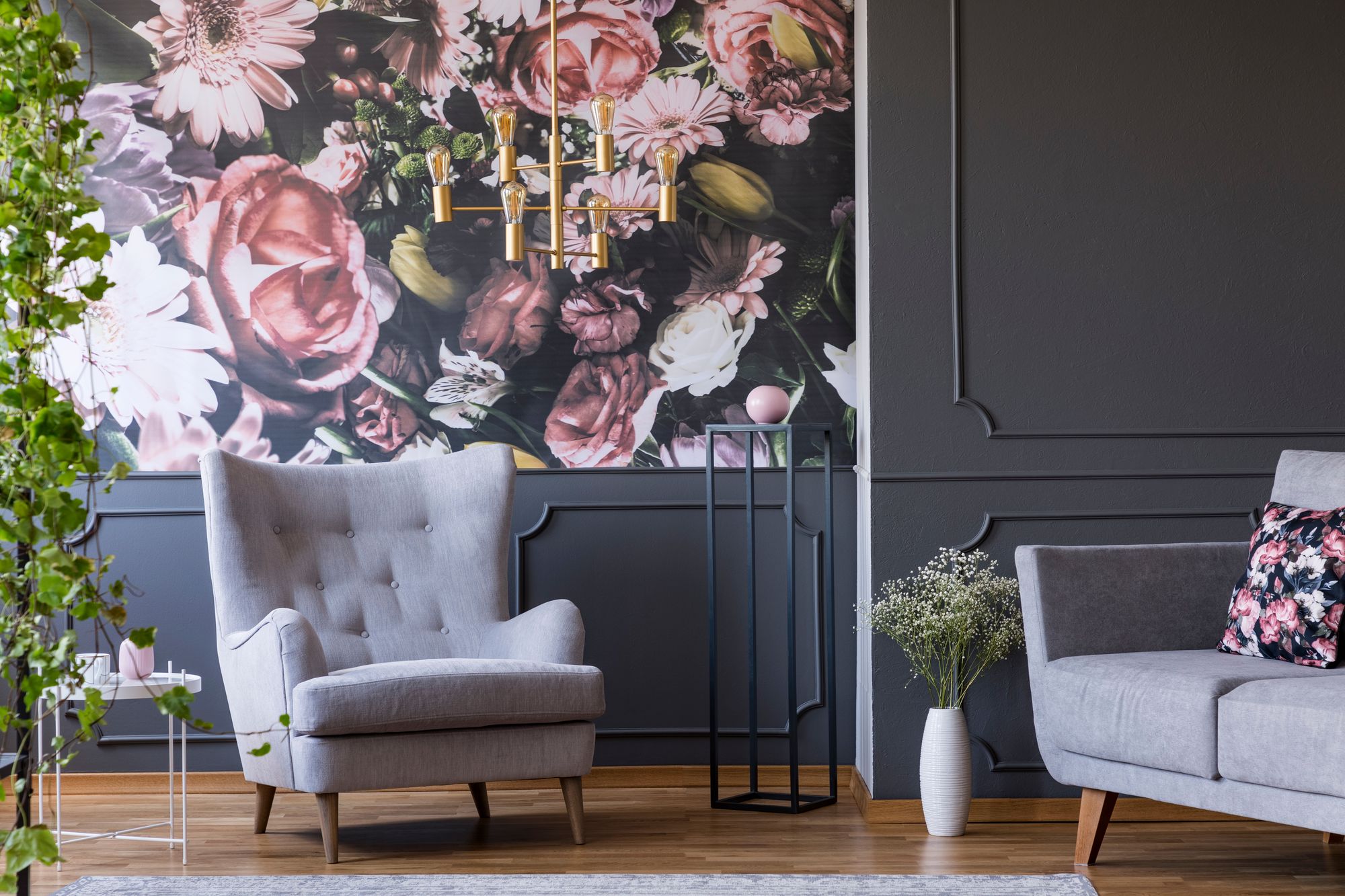 Grey Armchair Against Flowers Wallpaper In Dark Living Room Interior
