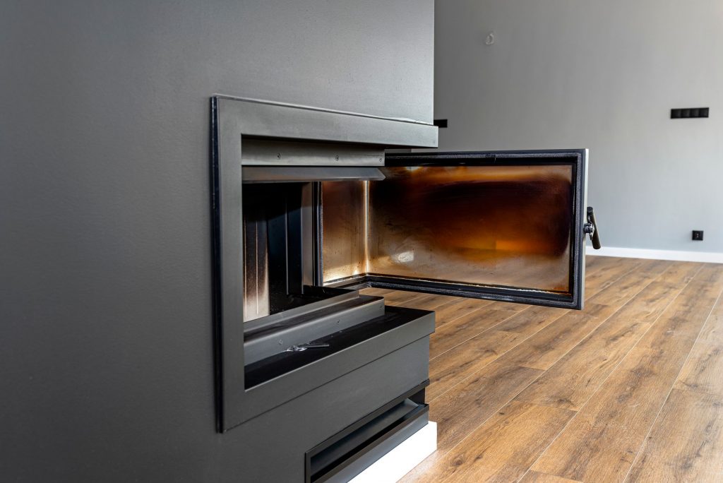 Dirty and Contaminated Corner Glass Door In A Modern Fireplace