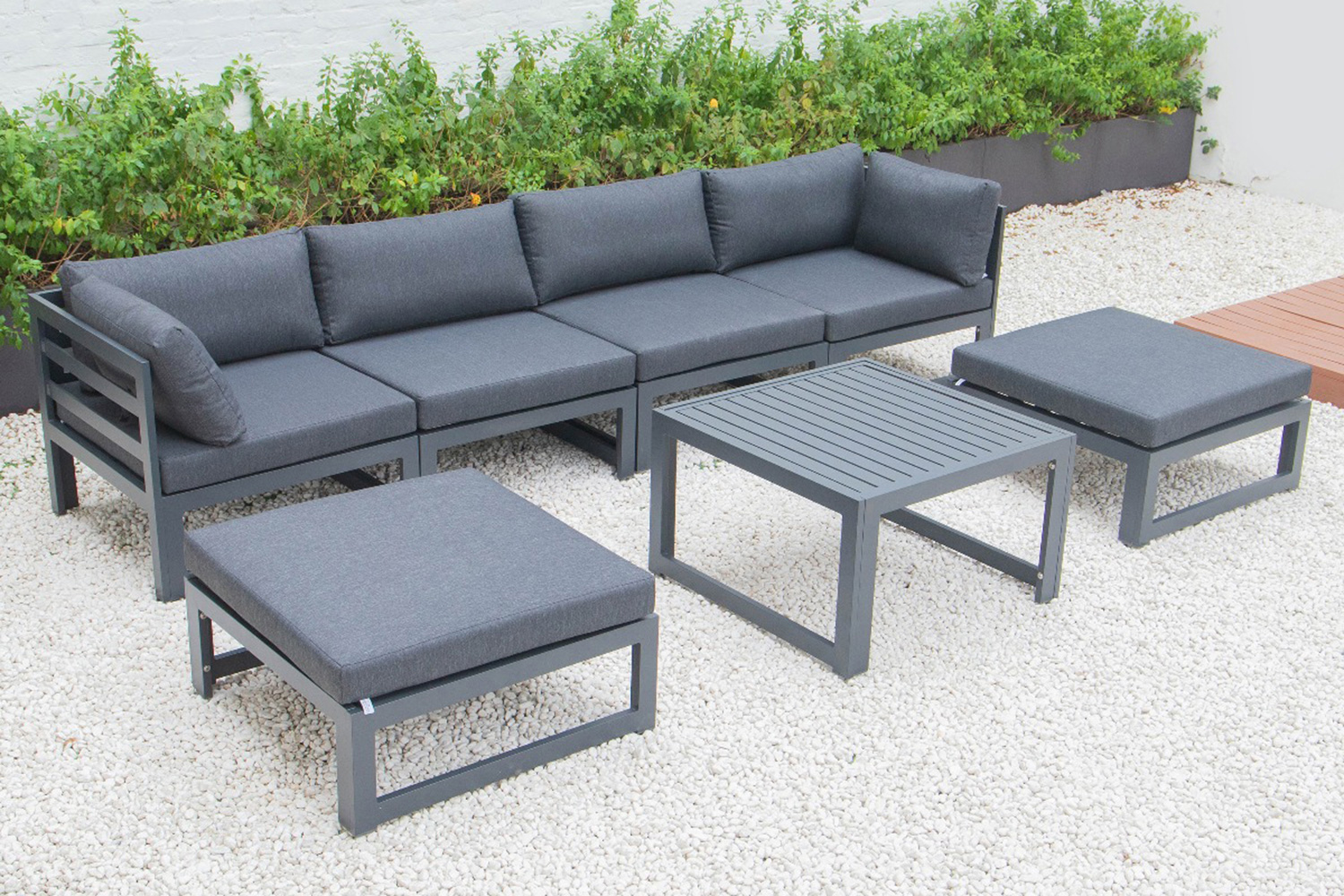 LeisureMod Chelsea 7-Piece Patio Ottoman Sectional and Coffee Table Set Black Aluminum with Cushions - Black